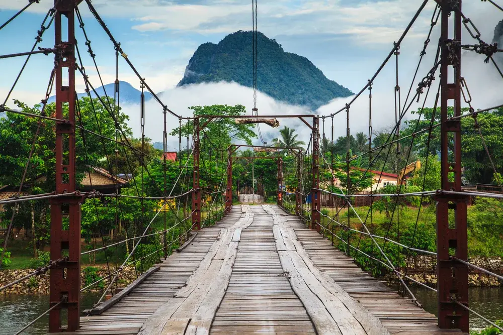 Gorgeous wood bridge over a river in Vang Vieng during the best time to go to Laos