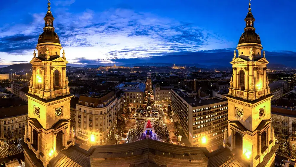 Saint Stephan Basilica at dusk lit up in a panorama view from above during the cheapest time to visit Hungary