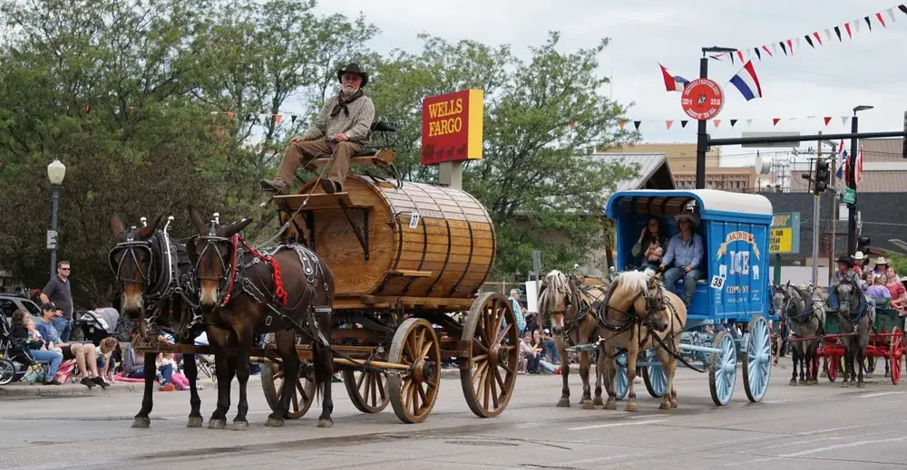 Several covered wagons pictured making their way down the street in Cheyenne
