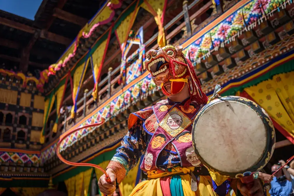 Buddhist monk dancing during Paro Tsechu Monastery festival during the best time to visit Bhutan