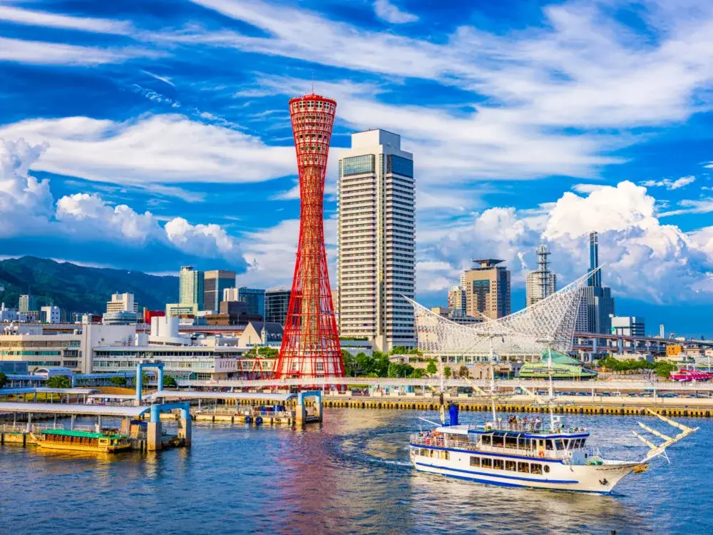 Water view of Kobe, a must-visit place in Japan, on a clear day with only a few clouds in the sky
