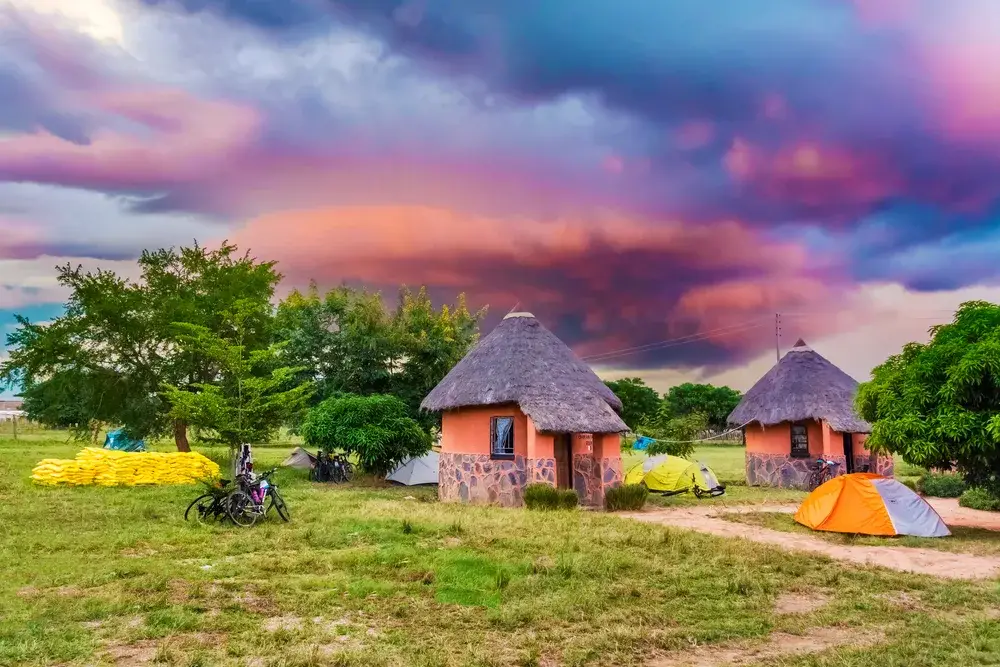 Idyllic village of Kalomo with its small pink huts pictured for a piece titled Is Zambia Safe to Visit
