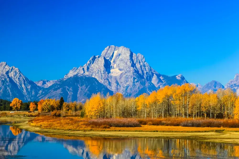 Amazing view of the enormous Grand Teton National Park, one of the best places to visit in Wyoming, as seen on a clear fall day