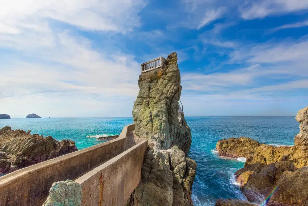 Unique observation point built on top of a rock formation sticking straight up, as seen on a nice day during the best time to go to Mazatlan