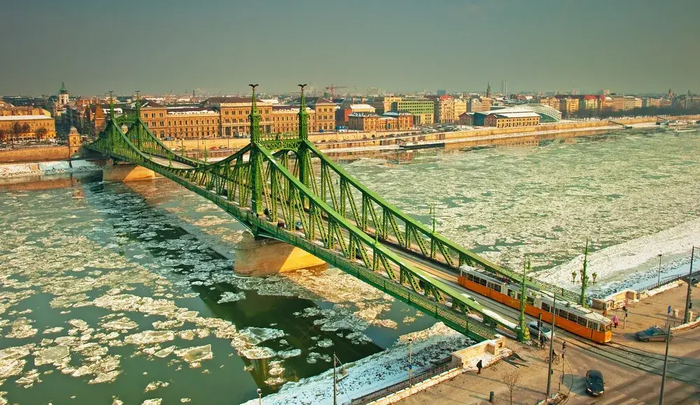 Budapest Chain Bridge with ice on the Danube River during winter, the worst time to visit Hungary