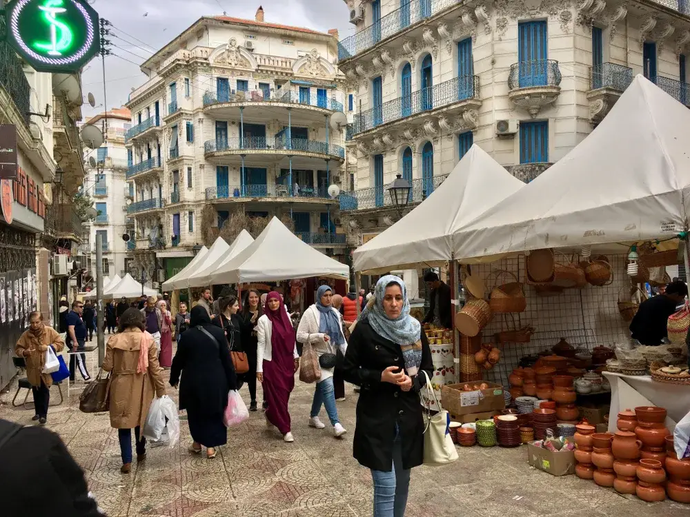 Woman in headscarfs in an open-air market pictured in Algiers for a piece on whether or not Algeria is safe to visit