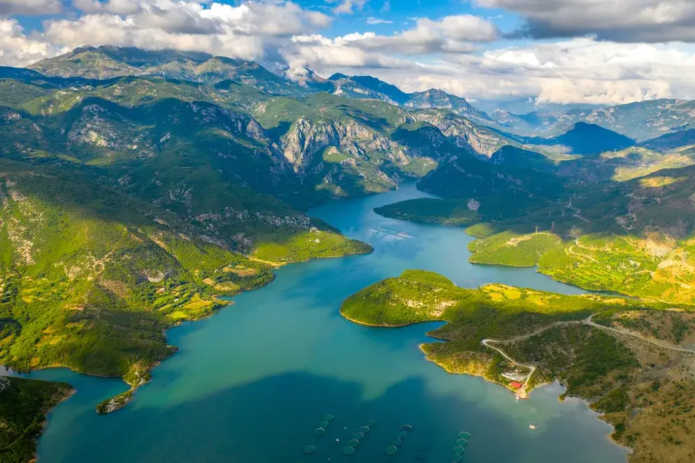 The mountains and lakes of Albania seen from an aerial perspective during the best time to visit Albania with warm weather and water