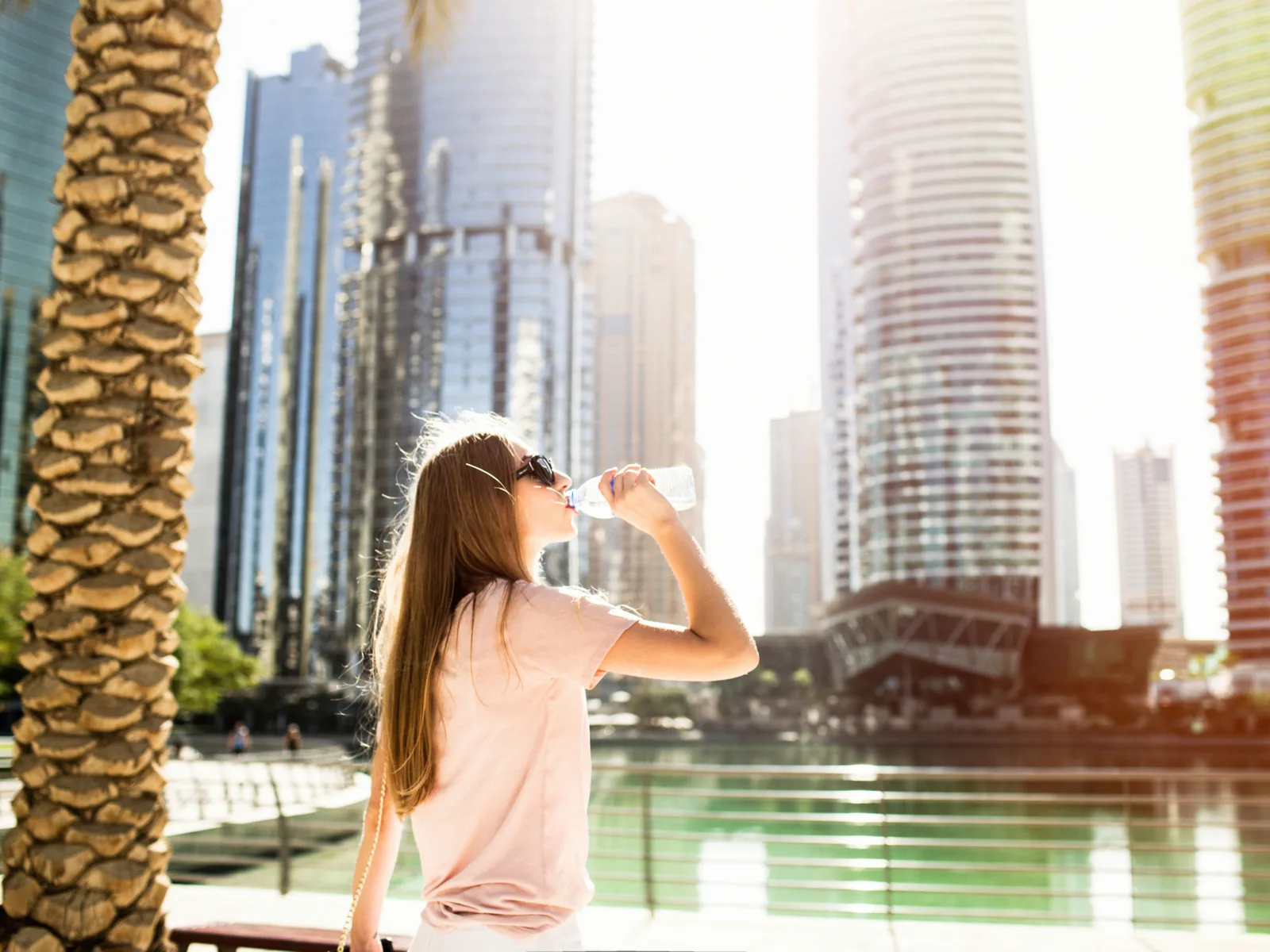 Woman drinking water during the cheapest time to visit Dubai