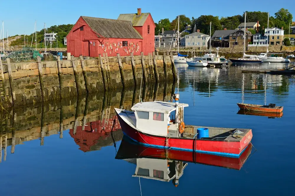 Harbor in Rockport pictured on a still day in the spring, the overall best time to visit New England