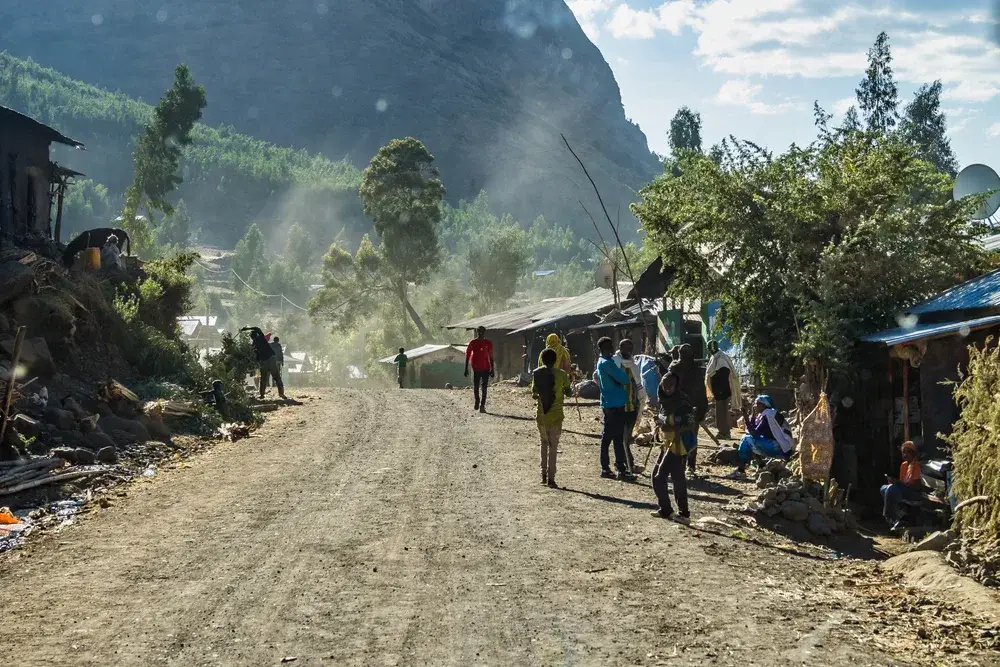 Villagers mulling about on a dirt road in Laibela for a piece titled Is Ethiopia Safe to Visit