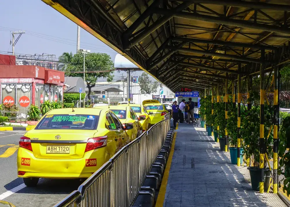 Taxis lining the street at the airport in Manila