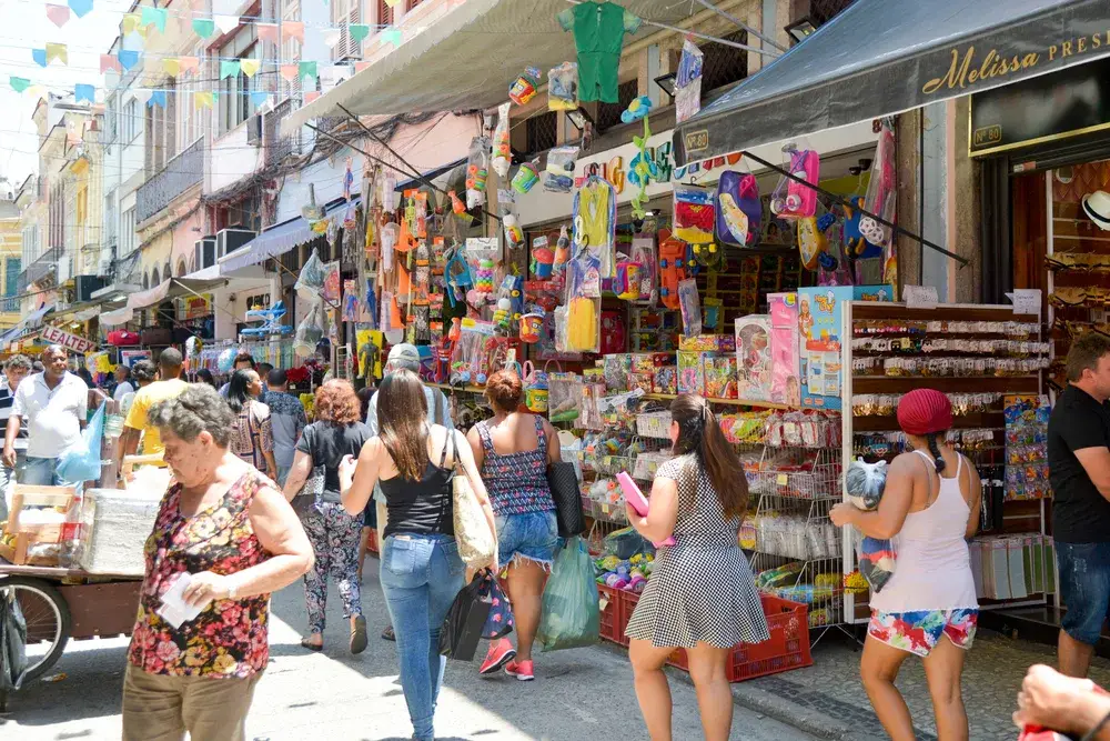 People walking along the street and shopping in Rio de Janeiro in an open-air market