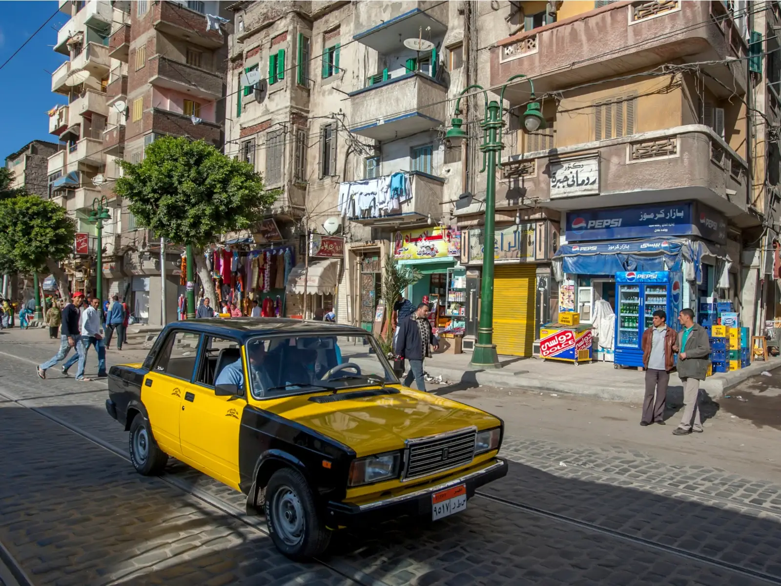 ALEXANDRIA, EGYPT - MARCH 22, 2010 : A taxi drives down a road past apartment buildings in a suburb of Alexandria in Egypt. for a piece on whether or not Egypt is safe