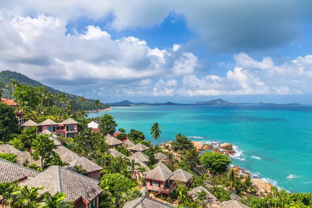 As one of the best places to visit in Thailand, a photo of Koh Samui pictured from the top of the hill looking out over the ocean