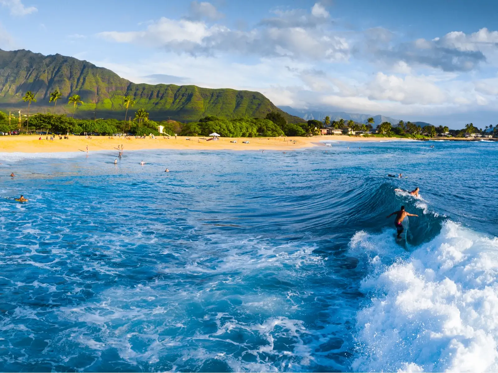 Surfer riding the waves in one of Hawaii's neighborhoods to avoid, Makaha, for a piece titled Is Hawaii Safe