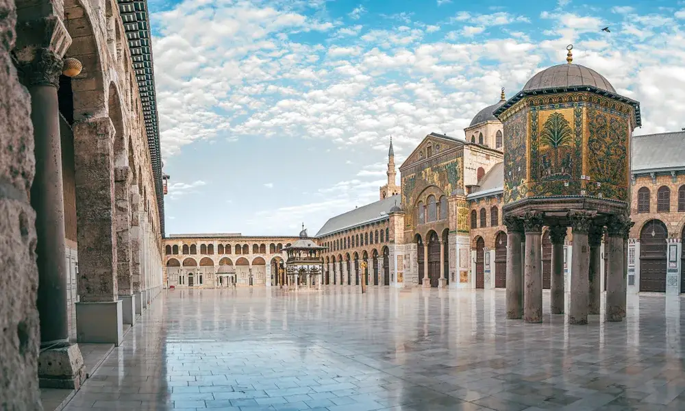 Panoramic day view of the Umayyad Mosque with partly cloudy skies pictured for a piece on is Syria safe