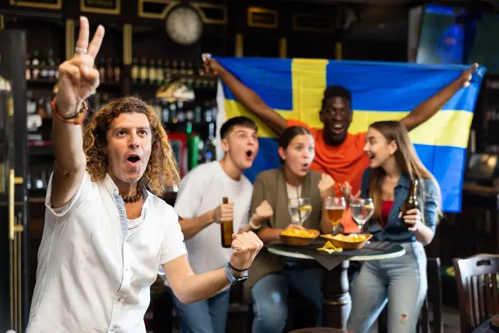 Swedish football fans in a sports bar cheering on a game for a piece on Is Sweden Safe