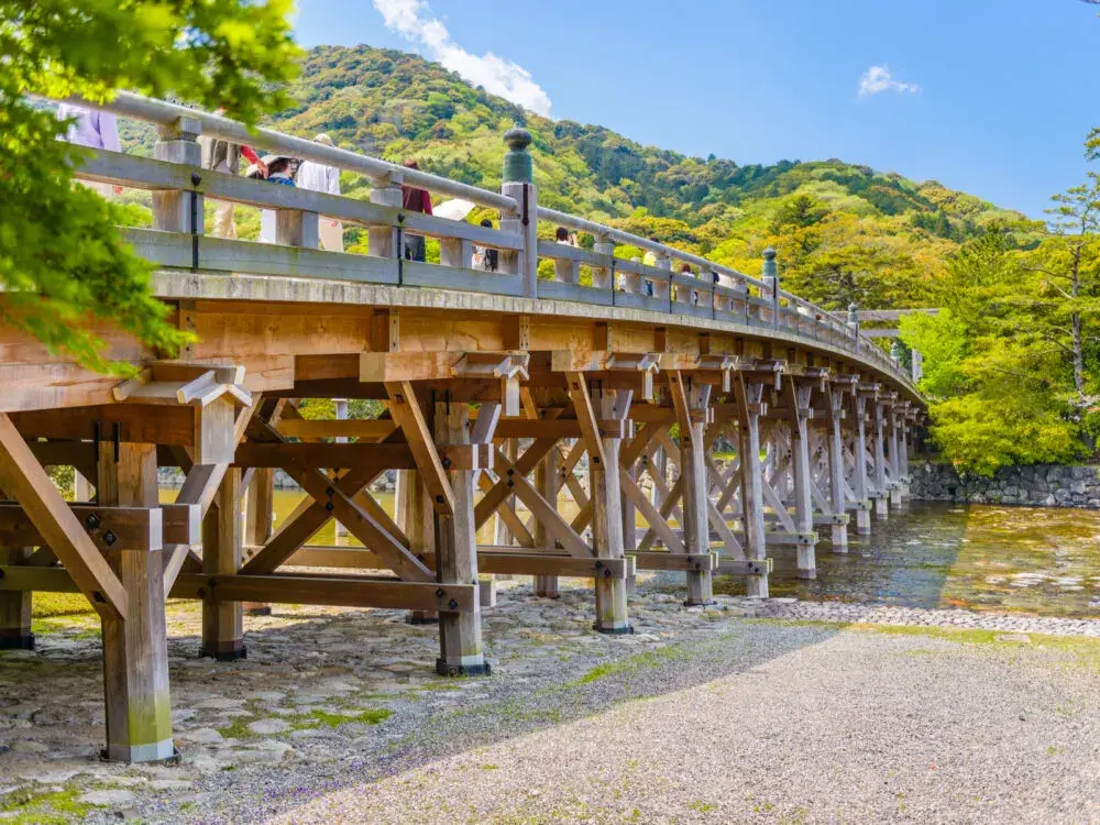Bridge in Ise Jingu, a top pick for the best place to visit in Japan, as seen on a clear day with gorgeous rocks and trees around it
